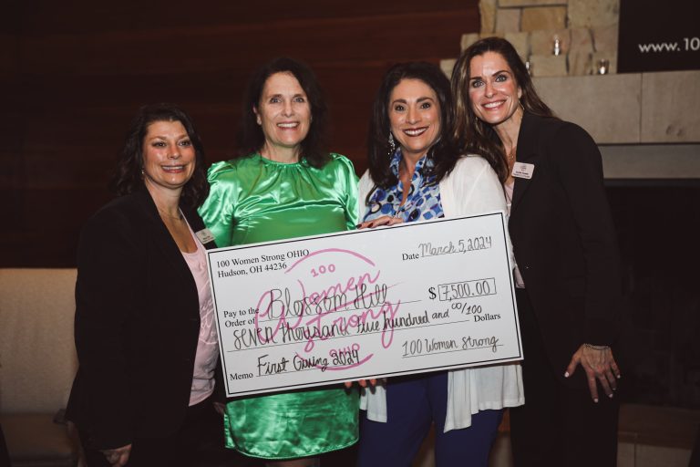 MaryJo and Jenn smiling with grant recipient, Blossom Hill
