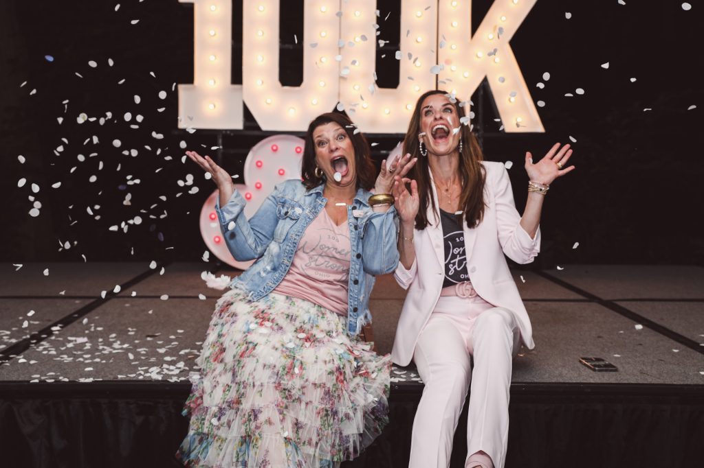 MaryJo and Jenn - founders of 100 Women Strong celebrating