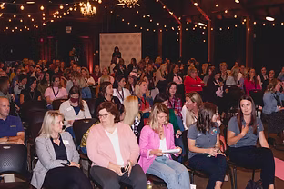 Giving event candid with chairs and attendees