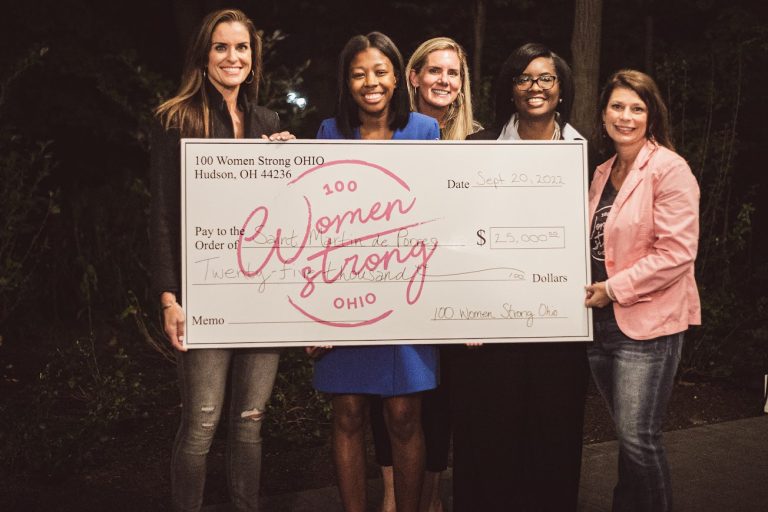 Saint Martin de Porres group of ladies holding large check
