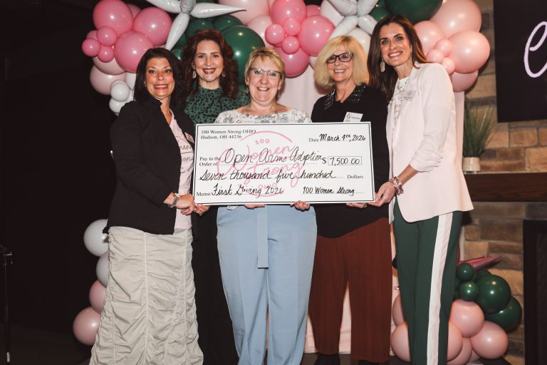 Ladies holding check at giving event