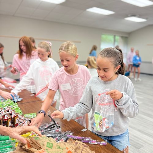 Girls packing snack bags at event